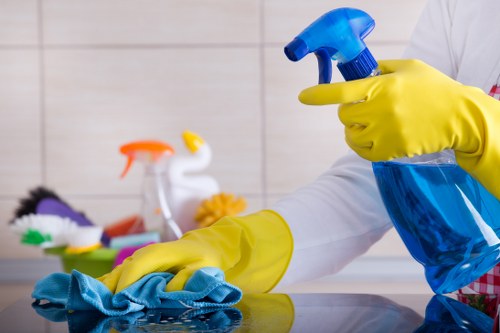 Cleaner working in a modern Brentford apartment kitchen